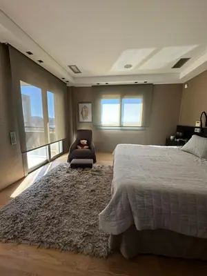 a bedroom with a large bed and a chair at BonVilla Seaview Oasis in Anavissos