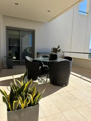 a patio with a table and chairs and plants at BonVilla Seaview Oasis in Anavissos