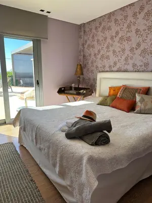 a bedroom with a bed with a hat on it at BonVilla Seaview Oasis in Anavissos