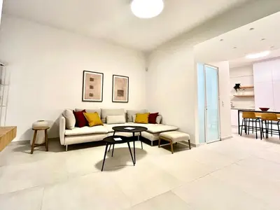 a living room with a couch and a table at New 1BR Apt modern and light in Athens