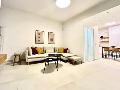 a living room with a couch and a table at New 1BR Apt modern and light in Athens