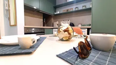 a kitchen with a table with glasses and a vase at Downtown & Cozy Kolonaki in Athens