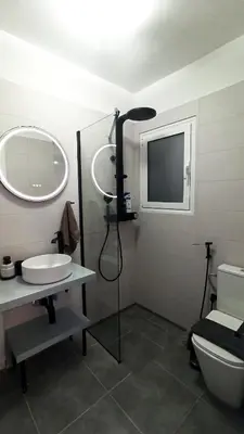 a bathroom with a toilet and a sink and a mirror at Downtown & Cozy Kolonaki in Athens