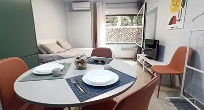 a dining table and chairs in a living room at Downtown & Cozy Kolonaki in Athens