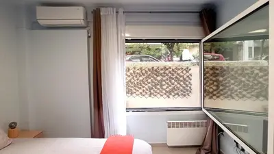 a bedroom with a window with a view of a street at Downtown & Cozy Kolonaki in Athens