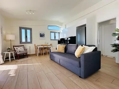 a living room with a couch and a table at Top-Floor 2BR Penthouse with Stunning Sea View in Athens