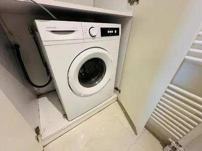 a washer and dryer in a small room at Top-Floor 2BR Penthouse with Stunning Sea View in Athens