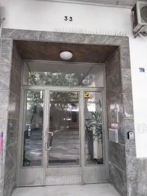an entrance to a building with a glass door at Jungle Lodge Athens at metro in Athens