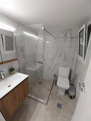 a bathroom with a shower and a toilet and a sink at Jungle Lodge Athens at metro in Athens