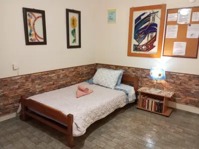 a small bedroom with a bed and a table at ΕΥΧΑΡΙΣΤΗ Διαμονη in Athens