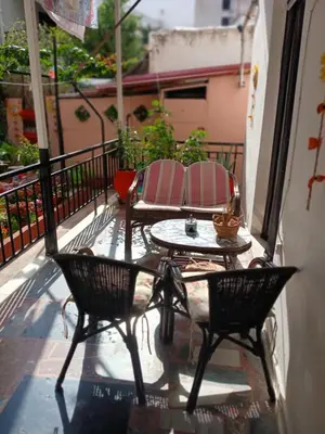 a patio with two chairs and a table on a balcony at ΕΥΧΑΡΙΣΤΗ Διαμονη in Athens