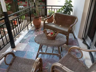 a balcony with a chair and a table with a basket at ΕΥΧΑΡΙΣΤΗ Διαμονη in Athens