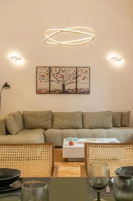 a living room with a couch and a table at Belle Étage 4BD 3BA Apt Kypseli Athens in Athens