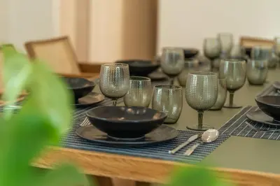 a table with wine glasses and bowls on it at Belle Étage 4BD 3BA Apt Kypseli Athens in Athens