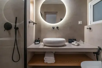 a bathroom with a sink and a mirror at Belle Étage 4BD 3BA Apt Kypseli Athens in Athens