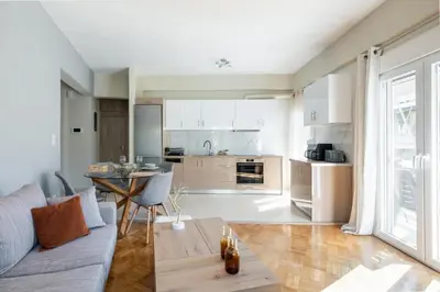 a living room with a couch and a table at HELIOS sunny comfortable apartment in Athens