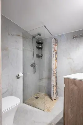 a shower with a glass door in a bathroom at HELIOS sunny comfortable apartment in Athens