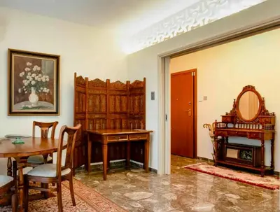 a living room with a table and a dining room at Charming Flat with Traditional & Elegant Style in Piraeus
