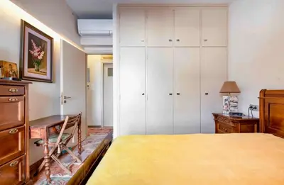 a bedroom with a bed and a desk and cabinets at Charming Flat with Traditional & Elegant Style in Piraeus