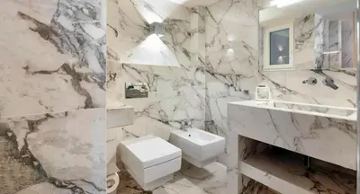 a marble bathroom with a sink and a toilet at Charming Flat with Traditional & Elegant Style in Piraeus