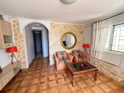a living room with a couch and a table at Laguna in Ayía Paraskeví