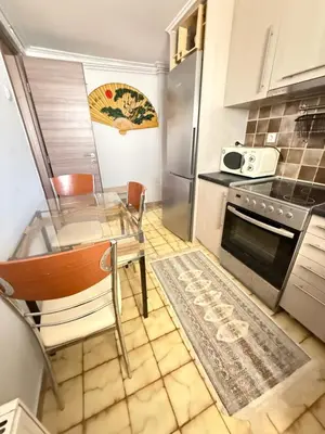 a kitchen with a glass table and a stove at Laguna in Ayía Paraskeví