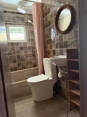 a bathroom with a toilet and a sink at Laguna in Ayía Paraskeví