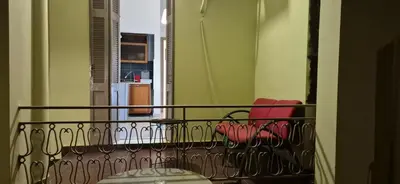 a balcony with two red chairs and a window at knezevic resorts 2 in Athens