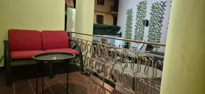 a red chair and a table on a balcony at knezevic resorts 2 in Athens