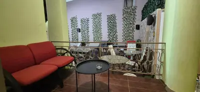 a waiting room with a red couch and a table at knezevic resorts 2 in Athens