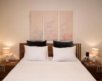 a bedroom with a large white bed with two lamps at Pro2Acropolis in Athens