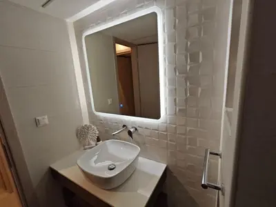 a bathroom with a white sink and a mirror at Pro2Acropolis in Athens