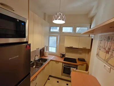 a small kitchen with a sink and a microwave at Pro2Acropolis in Athens