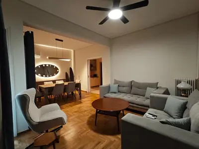 a living room with a couch and a table at Pro2Acropolis in Athens