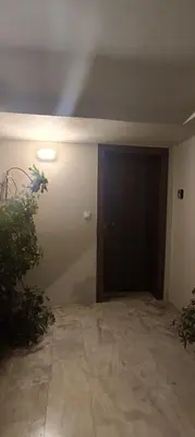 an empty room with a door and a plant at CityZen Apartment in Athens