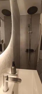 a bathroom with a sink and a shower at CityZen Apartment in Athens