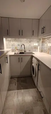 a kitchen with a sink and a washing machine at CityZen Apartment in Athens