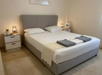 a bedroom with a large bed with two night stands at The Athenian Escape Elegant 2BR Apt in Galatsi in Athens