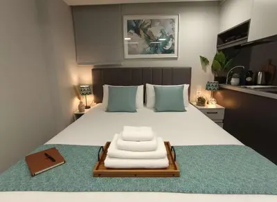 a bed with a tray with towels on it at Your Little Athenian Retreat Ampelokipoi Studio in Athens