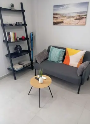 a living room with a couch and a table at Your Little Athenian Retreat Ampelokipoi Studio in Athens