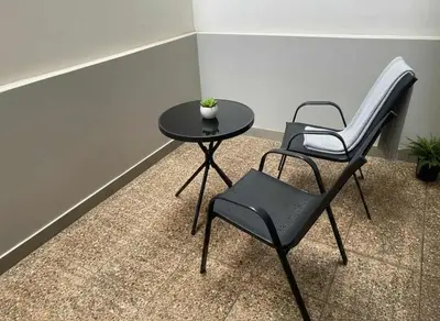 two chairs and a table in a room at Your Little Athenian Retreat Ampelokipoi Studio in Athens