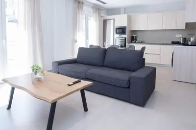a living room with a blue couch and a coffee table at Brand New Spacious 3 Bd Home in Trendy Kipseli in Athens