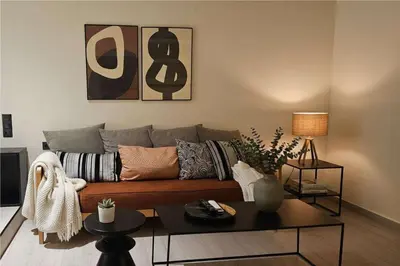 a living room with a couch and a table at The Victoria Suite Chic & Modern Studio Stay in Athens