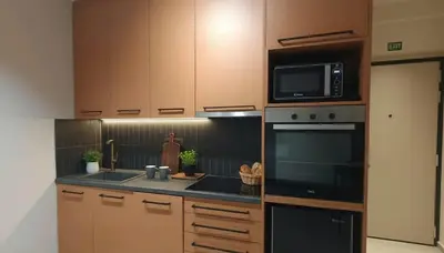 a kitchen with a microwave and a sink at The Victoria Suite Chic & Modern Studio Stay in Athens