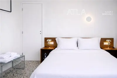 a hotel room with a bed and two lamps at Atla Living Athens in Athens