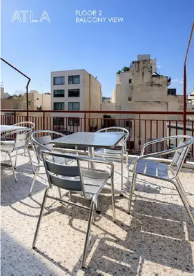 a group of chairs and a table on a roof at Atla Living Athens in Athens