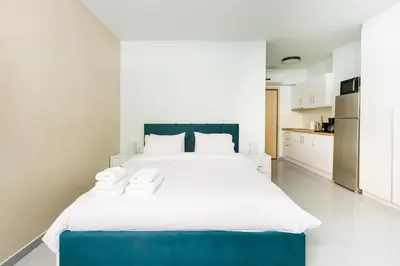 a bedroom with a large bed with a blue headboard at Charming 1BR Studio in the Heart of Athens in Athens