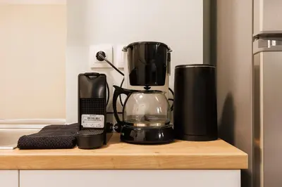 a coffee maker on a wooden shelf in a kitchen at Charming 1BR Studio in the Heart of Athens in Athens