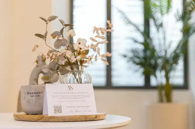 a table with a vase of flowers and a sign at AthenianNest Asomaton Boutique Studio in Psyrri near Acropolis in Athens