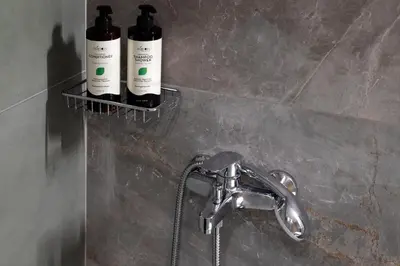 two bottles of wine are on a shelf in a bathroom at AthenianNest Asomaton Boutique Studio in Psyrri near Acropolis in Athens